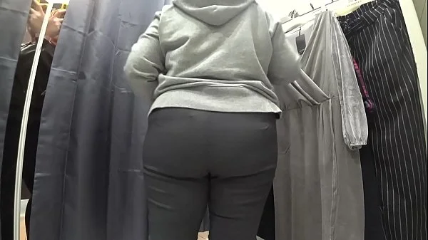 A plump milf with a juicy ass in white panties and big tits in a bra got into the lens of a hidden camera in a public dressing room.