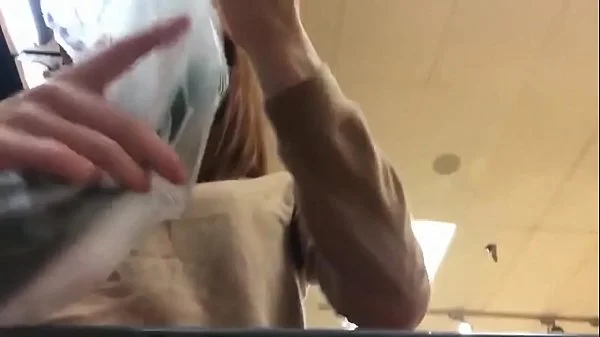 Cute Redhead shops for and uses cucumber