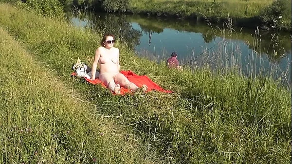 MILF sexy Frina on river bank undressed and sunbathes naked. Random man fisherman watching for her, and in the end decided to join naked woman. Wild beach. Nudist beach. Public nudity. Public exposure. Naked in public